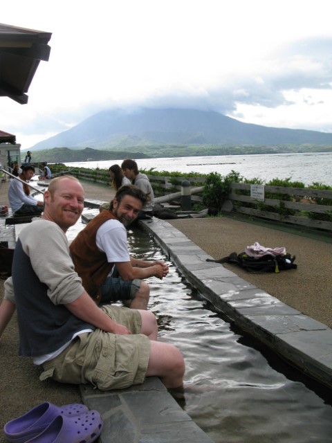 Foot spa with Sakurajima volcano smoking in the background